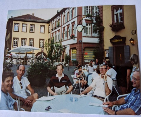 People sitting at a table in a German town square