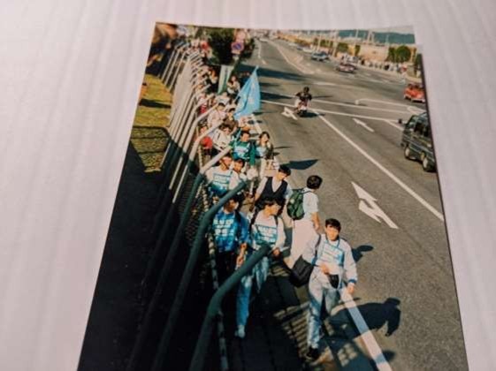 Protestors walking on the side of a road