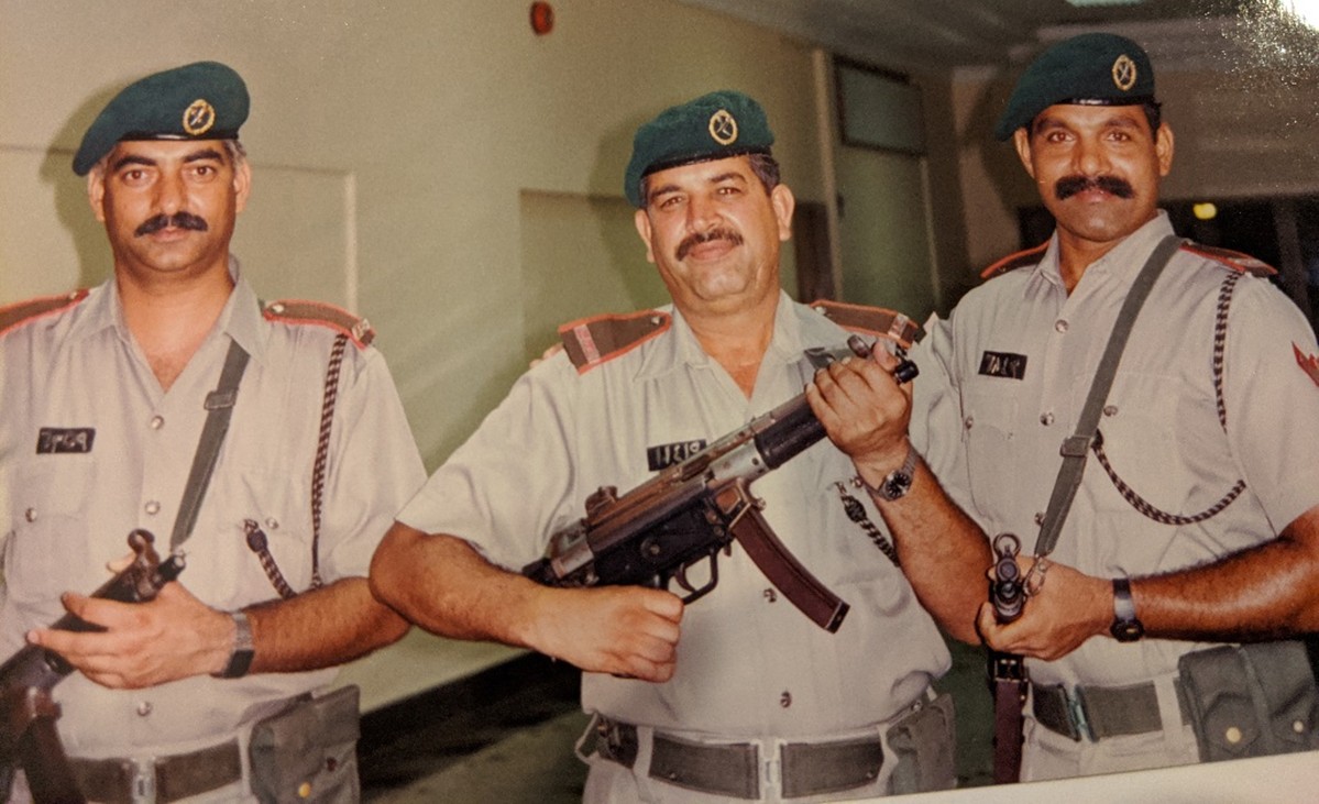 Three men with uniforms and rifles