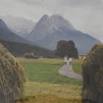 A path way through hay fields near the alps.